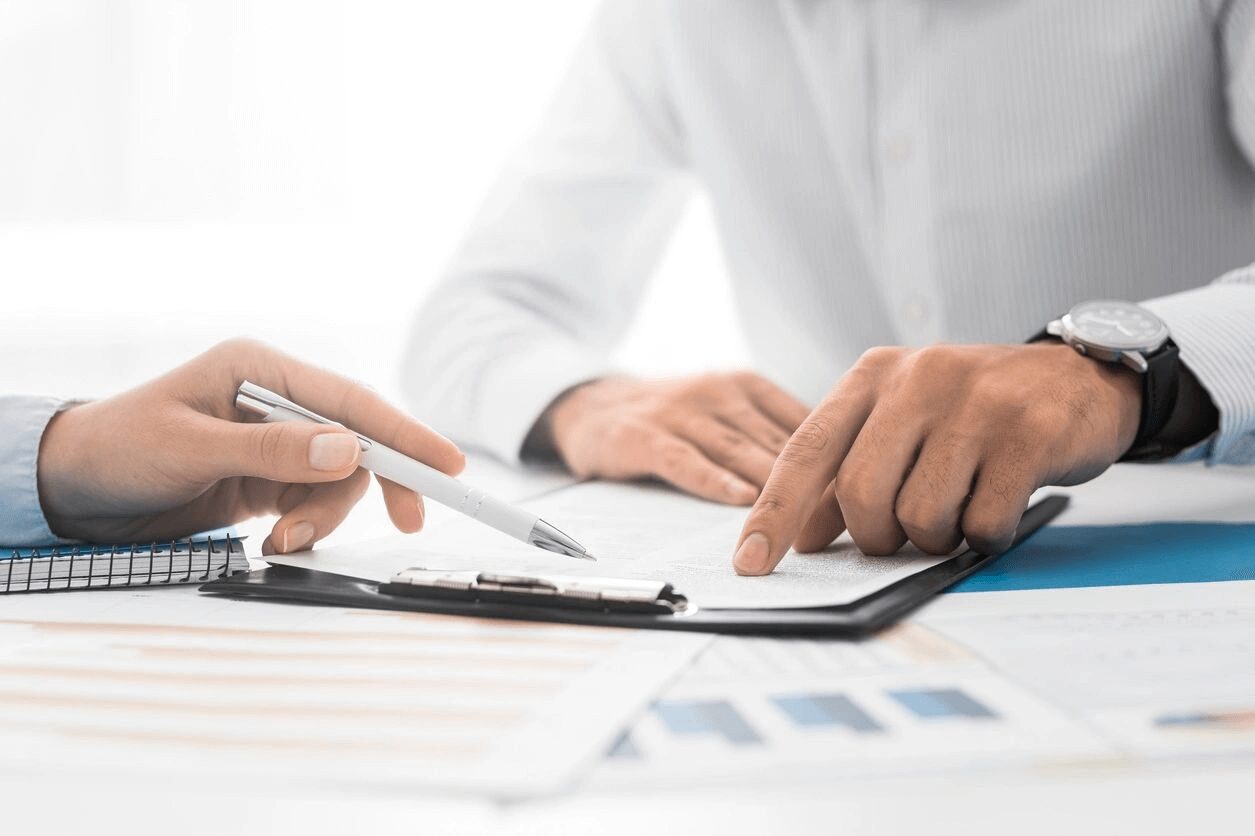 Closeup Shot of Two Unrecognisable Businessmen Going Through Paperwork Together