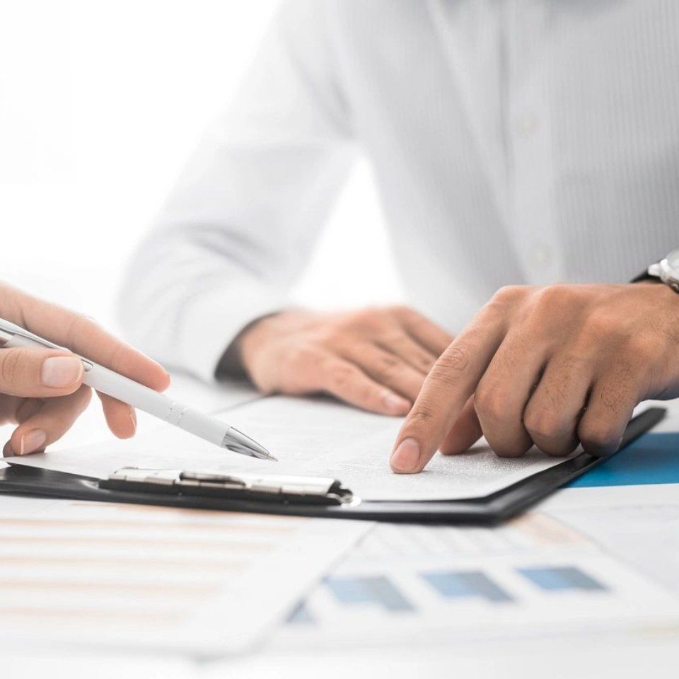 Closeup Shot of Two Unrecognisable Businessmen Going Through Paperwork Together